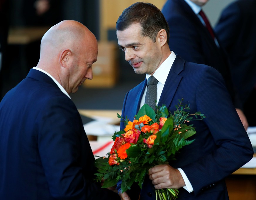 Mike Mohring of the Christian Democratic Union (CDU) congratulates FDP candidate Thomas Kemmerich after he was elected new Thuringia premier at the state parliament in Thuringia in Erfurt, Germany, Fe ...