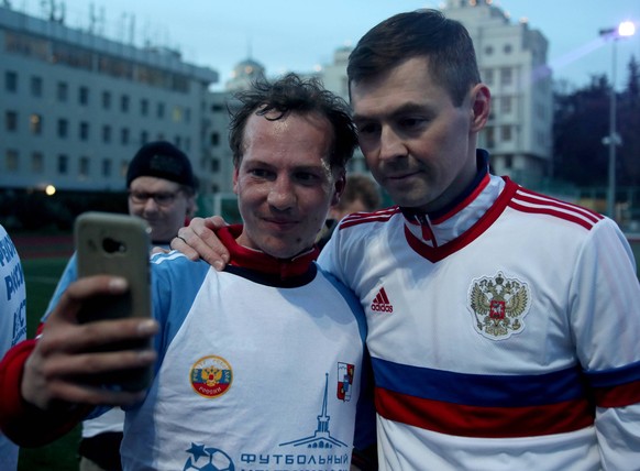 SOCHI, RUSSIA - MARCH 26, 2021: Diniyar Bilyaletdinov R, an ex-player of the Russian men s national football team, poses for a selfie with a participant in a football tournament for people with disabi ...