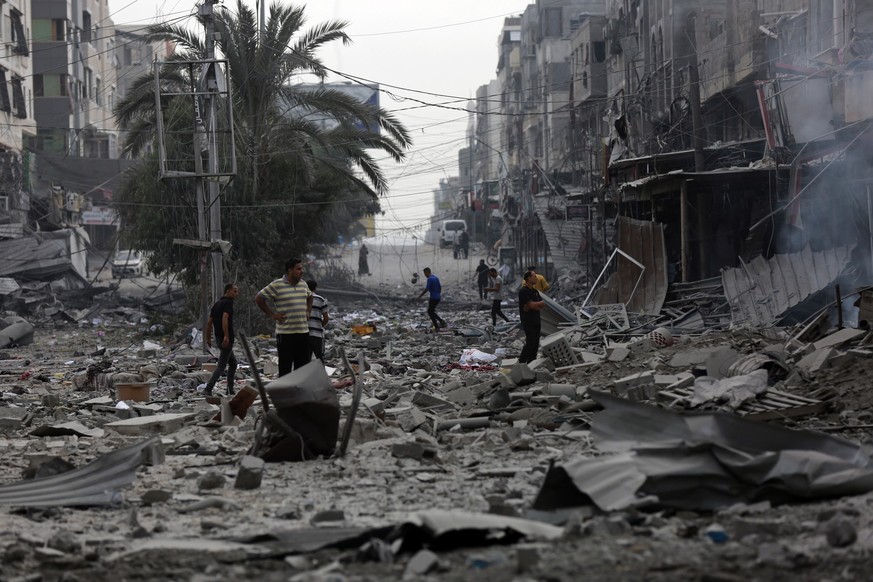 Palestinians inspect the damage of destroyed buildings following Israeli airstrikes on Gaza City, Friday, Oct. 27, 2023. (AP Photo/Abed Khaled)