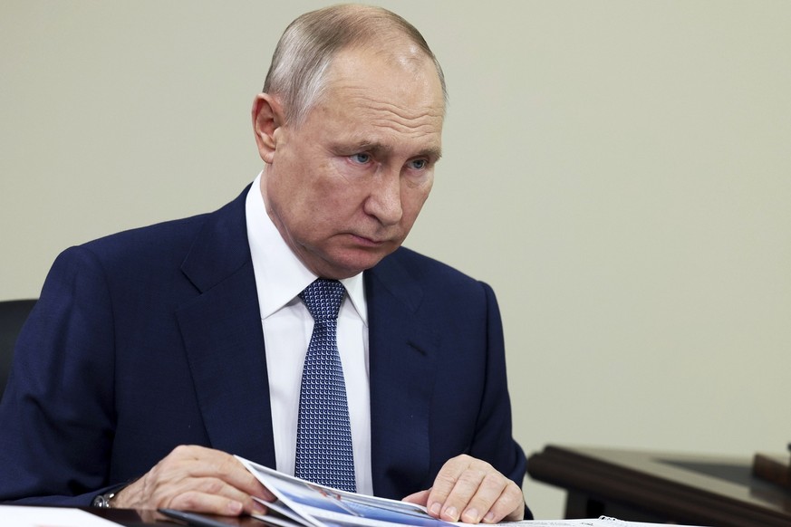 Russian President Vladimir Putin listens to Perm Territory Governor Dmitry Makhonin during their meeting in Perm, Russia, Thursday, Oct. 19, 2023. (Gavriil Grigorov/Pool Photo via AP)