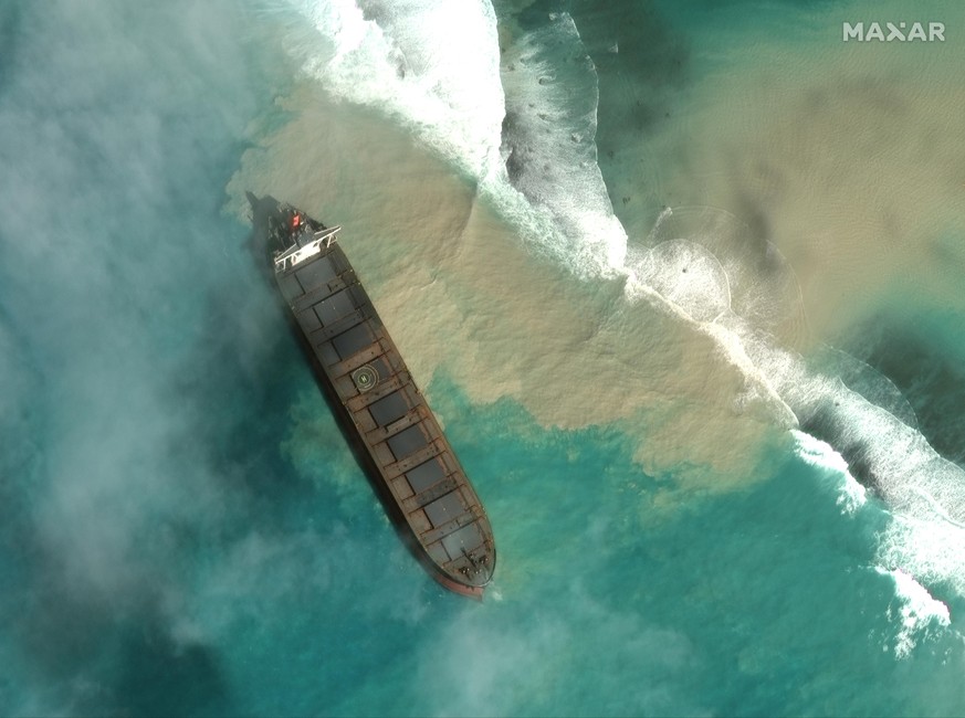 In this satellite image provided by 2020 Maxar Technologies on Friday, Aug. 7, 2020, an aerial view of the MV Wakashio, a bulk carrier ship that recently ran aground off the southeast coast of Mauriti ...
