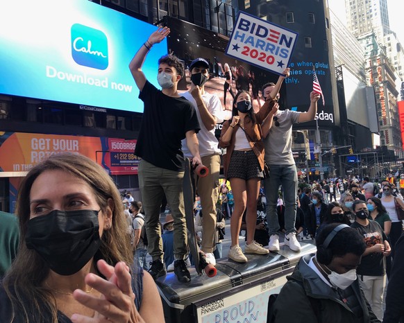 People celebrate in Times Square after former vice president and Democratic presidential candidate Joe Biden was announced as the winner over President Donald Trump to become the 46th president of the ...