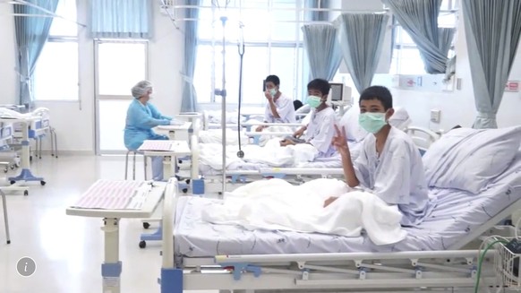 In this image made from video, released by the Thailand Government Spokesman Bureau, three of the 12 boys are seen recovering in their hospital beds after being rescued along with their coach from a f ...
