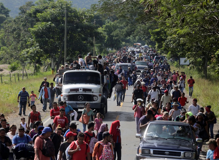 Hondurans fleeing from poverty and violence travel in a truck as part of their journey after leaving Ocotepeque, Honduras October 15, 2018 in a caravan toward the United States. REUTERS/Jorge Cabrera
