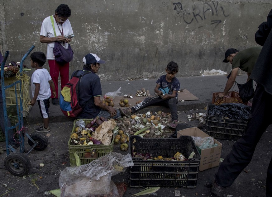 Venezolaner sammeln in der Nähe eines Straßenmarkts Gemüse-und Obstreste auf. Venezuela steckt in der schwersten politischen und wirtschaftlichen Krise seiner Geschichte.&nbsp;