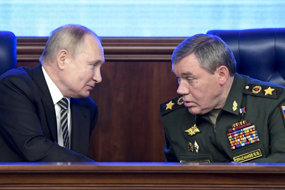 FILE - Russian President Vladimir Put, left, and Russian General Staff Valery Gerasimov talk to each other during a meeting in Moscow, Russia on Dec. 21, 2021. Putin has put Gerasimov directly in char ...