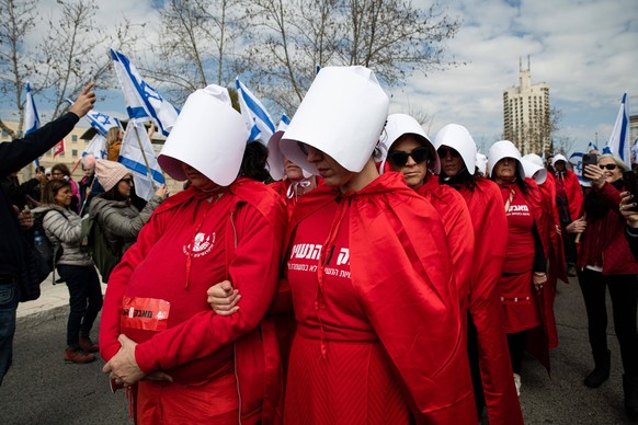 February 13, 2023, Jerusalem, Israel: Israeli women in a protestation act dressed as characters from ÃThe Handmaid s Talei series march during the demonstration. Over one hundred people protested as t ...