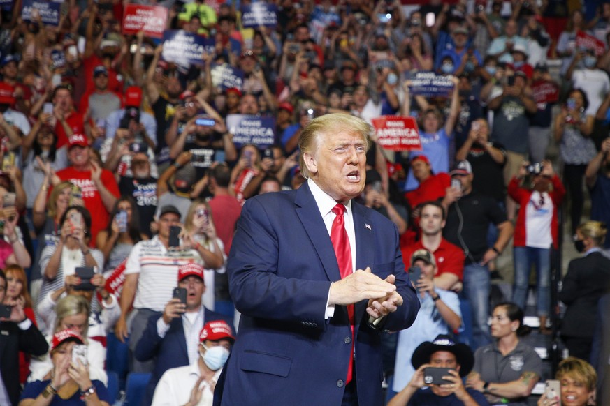 President Donald Trump claps while supporters cheer during his campaign rally at BOK Center in Tulsa, Okla., Saturday, June 20, 2020. (Ian Maule/Tulsa World via AP)