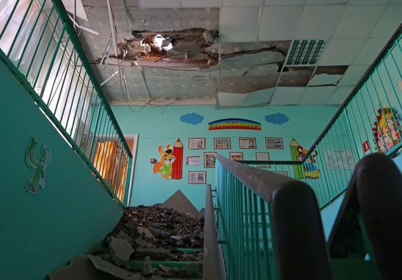 A view shows a hole in the roof of a kindergarten building hit by shelling, what local authorities called a Ukrainian military strike, in the course of the Russia-Ukraine conflict in Belgorod, Russia  ...