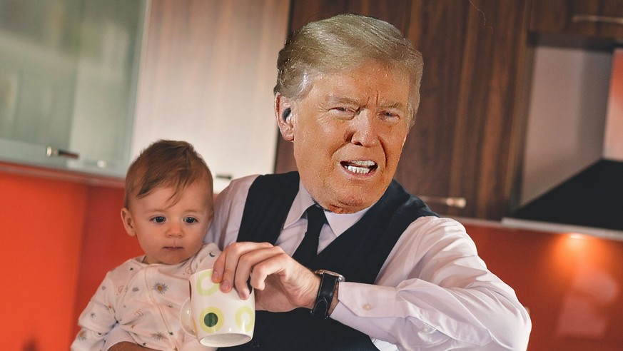 Single businessman father checking the time while holding baby boy in the kitchen