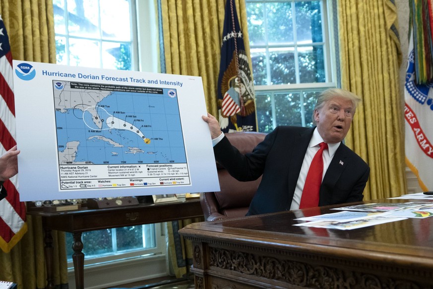 September 4, 2019, Washington, District of Columbia, USA: United States President Donald J. Trump holds a map that appears to show the course of Hurricane Dorian going through part of Alabama during a ...
