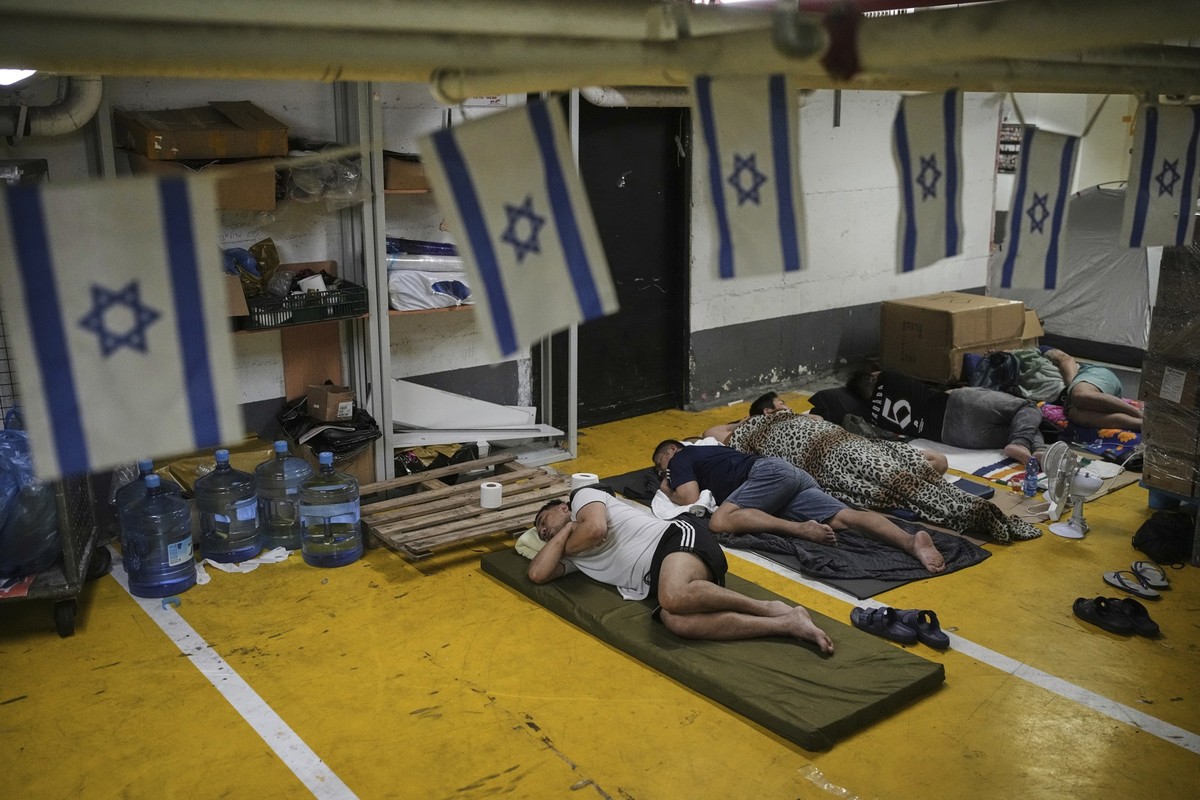 24.06.2025, Israel, Tel Aviv: Menschen ruhen sich aus und suchen Schutz in einer Tiefgarage als Vorsichtsmaßnahme gegen iranische Raketenangriffe. Foto: Ohad Zwigenberg/AP/dpa +++ dpa-Bildfunk +++