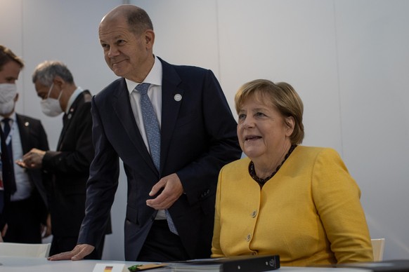 German Chancellor Angela Merkel and and Finance Minister Olaf Scholz take their seats at the start of a bilateral meeting with Singaporean Prime Minister Lee Hsien Loong, on the sidelines of the G20 W ...