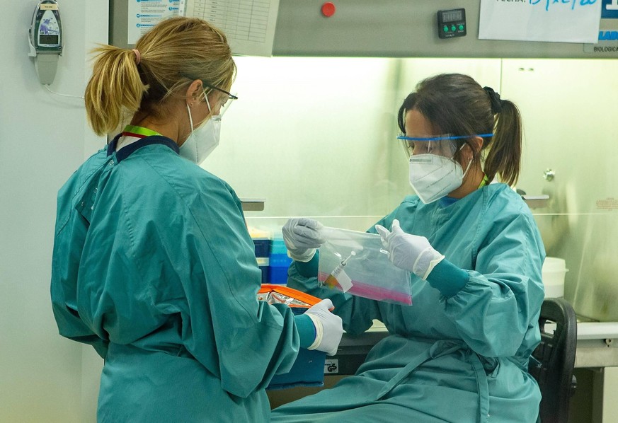 Two paramedics prepare to record data of the clinical trial of Janssen COVID-19 vaccine, which is in phase 3, that is being administered to several volunteers at Germans Trias i Pujol Hospital in Bada ...