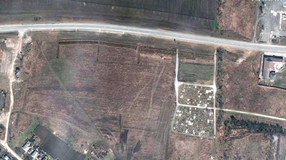 A satellite image shows an alleged mass grave in the village of Manhush, outside the besieged Ukrainian city of Mariupol, on April 3, 2022. Ukrainian officials on Tuesday April 18, 2022 identified the ...