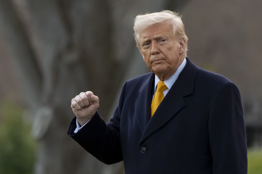 FILE - President Donald Trump pumps his fist before departing on Marine One from the South Lawn of the White House, Friday, March 7, 2025, in Washington. (AP Photo/Alex Brandon, File)