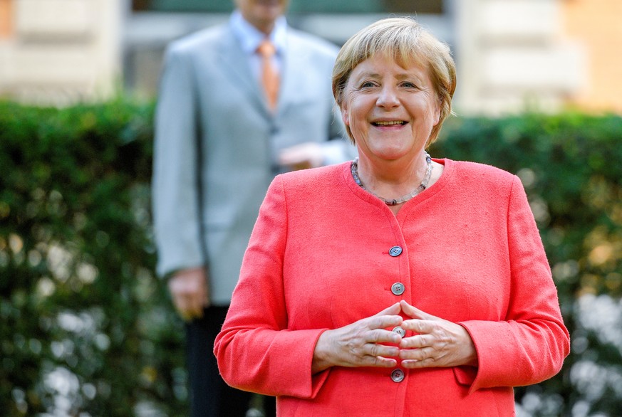 German Chancellor Angela Merkel poses for the media in front of the Staendehaus former parliament building prior to a North Rhine-Westphalian cabinet meeting in Duesseldorf, Germany, August 18, 2020.  ...