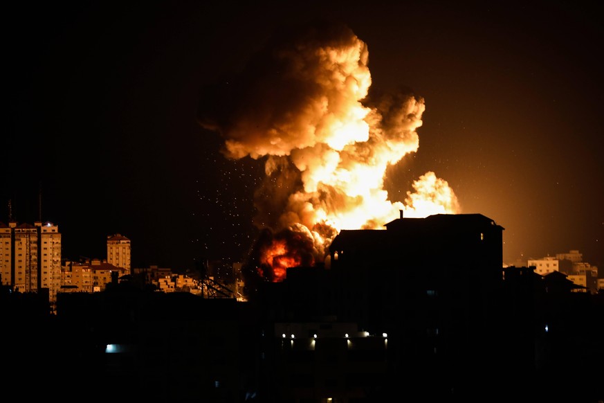 May 12, 2021, Gaza, Palestine: Smoke and flames rise from a building during an Israeli air strike amid a flare-up of Israeli-Palestinian violence in Gaza City. Gaza Palestine - ZUMAs197 20210512_zaa_s ...