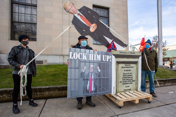 US: Activists topple symbolic Trump statue Devon Stackonis, Gene Stilp and Steve Connolley pose with a toppled symbolic statue of President Donald J. Trump. Longtime activist Stilp created the 14 foot ...