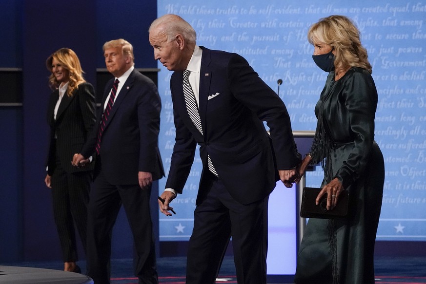 From l-r, first lady Melania Trump, President Donald Trump, Democratic presidential candidate former Vice President Joe Biden and Jill Biden, walk off stage at the conclusion of the first presidential ...