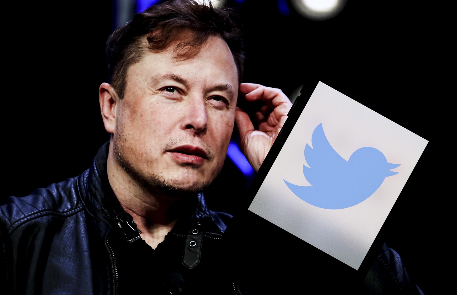 ANKARA, TURKIYE - APRIL 26: In this photo illustration, the image of Elon Musk is displayed on a computer screen and the logo of twitter on a mobile phone in Ankara, Turkiye on April 26, 2022. Twitter ...