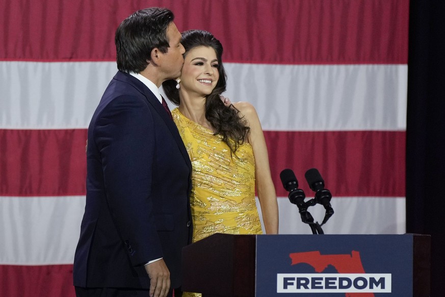 Incumbent Florida Republican Gov. Ron DeSantis kisses his wife Casey as he speaks to supporters at an election night party after winning his race for reelection in Tampa, Fla., Tuesday, Nov. 8, 2022.  ...