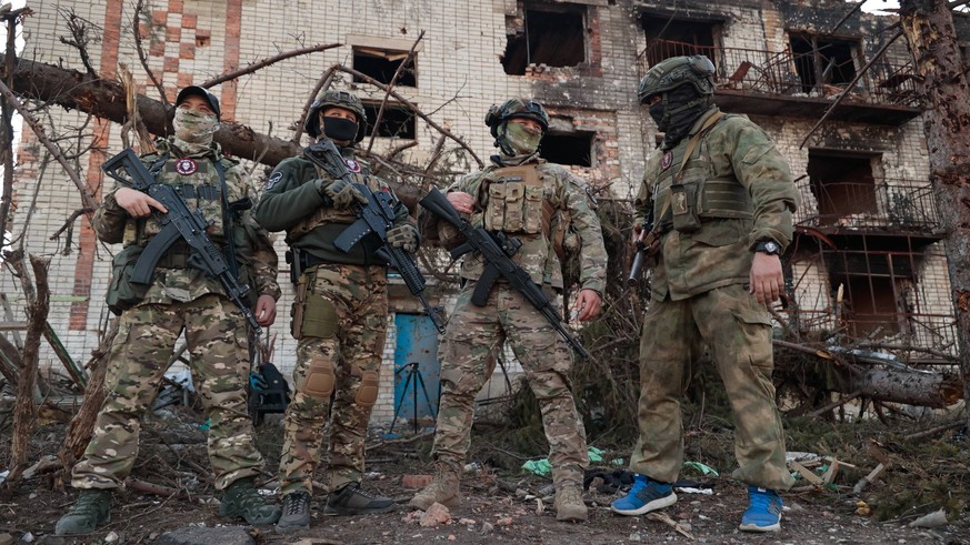 UKRAINE, DONETSK REGION - APRIL 10, 2023: Wagner Group soldiers are seen by a damaged building in the city of Artyomovsk Bakhmut. Artyomovsk is located in the Kiev-controlled area of the Donetsk Peopl ...