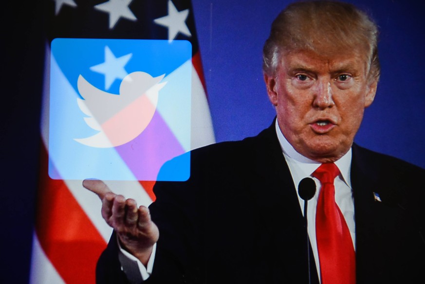 July 26, 2018 - Krakow, Poland - A double exposure image shows the President of United States of America, Donald Trump with social media logo Twitter in this photo illustration. Krakow Poland PUBLICAT ...