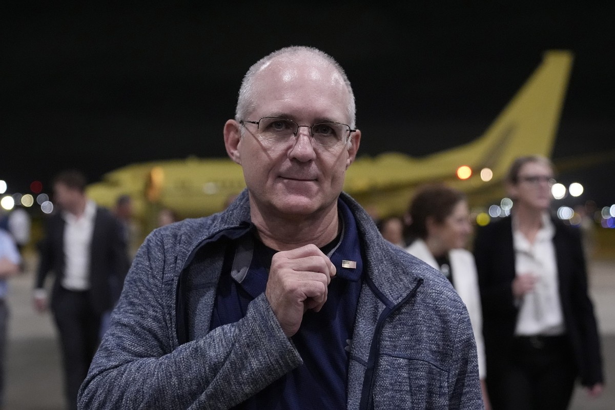 Paul Whelan shows a pin he received from President Joe Biden as he arrives at Kelly Field after being released by Russia, Friday, Aug. 2, 2024, in San Antonio. (AP Photo/Eric Gay)