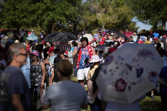 People wait in line to enter a rally with Republican presidential candidate, former President Donald Trump, Sunday, June 9, 2024, in Las Vegas. (AP Photo/John Locher)