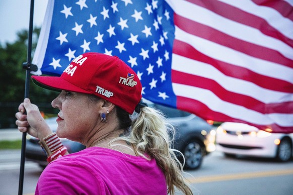 November 5, 2024, West Palm Beach, Florida, USA: Trump supporter, MARIA KORNSEL rallies outside of his Mar-A-Lago estate as they await the final results of the 2024 presidential elections. West Palm B ...