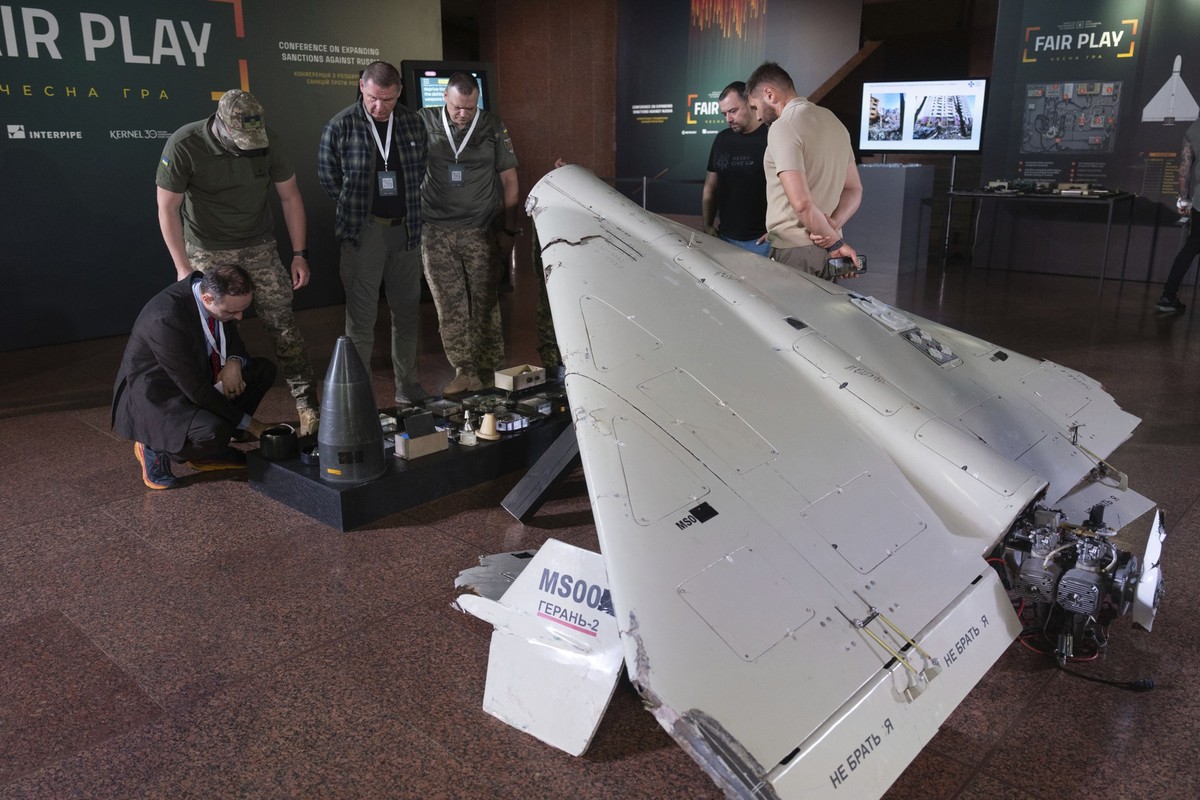 Visitors look at a damaged Iranian-made drone, Shahed, during the International Conference on Expanding Sanctions Against Russia in Kyiv, Ukraine, Friday, June 27, 2025. (AP Photo/Efrem Lukatsky)