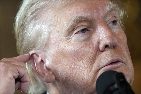 Republican presidential nominee former President Donald Trump talks about his ear during a news conference at his Mar-a-Lago estate Thursday, Aug. 8, 2024, in Palm Beach, Fla. (AP Photo/Alex Brandon)