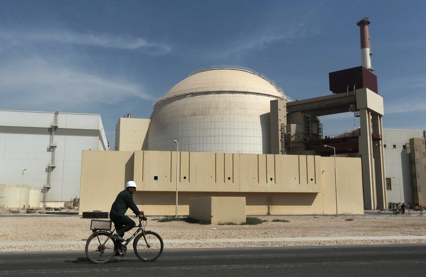 FILE - In this Oct. 26, 2010 file photo, a worker rides a bicycle in front of the reactor building of the Bushehr nuclear power plant, just outside the southern city of Bushehr, Iran. The chances for  ...