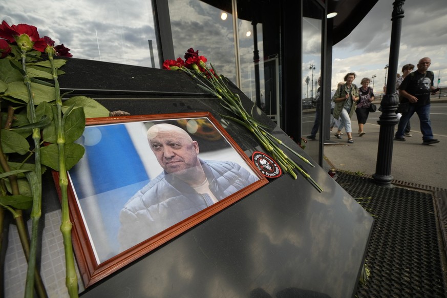 A portrait of the owner of private military company Wagner Group Yevgeny Prigozhin is installed at an informal memorial at a cafe owned by a Prigozhin&#039;s company in St. Petersburg, Russia, Friday, ...