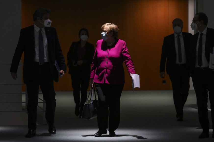 BERLIN, GERMANY - MARCH 03: German Chancellor Angela Merkel (C), Bavarian Premier Markus Soeder (L) and Berlin Mayor Michael Mueller (R) arrive to a press conference after a virtual meeting between Me ...