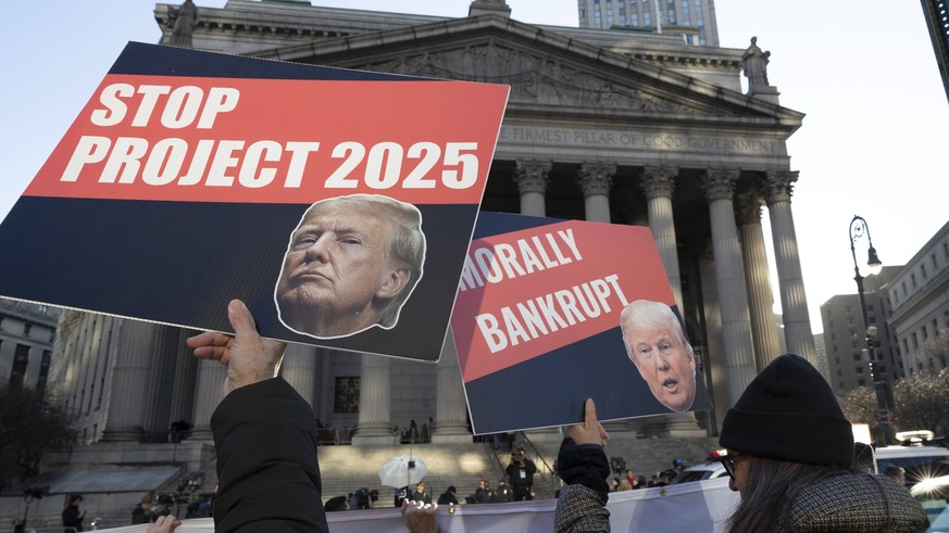 January 11, 2024, New York, New York, Usa: Anti-Trump protesters with Rise &amp; Resist hold signs and banners outside of the New York County Courthouse as police and media fill the area waiting for f ...