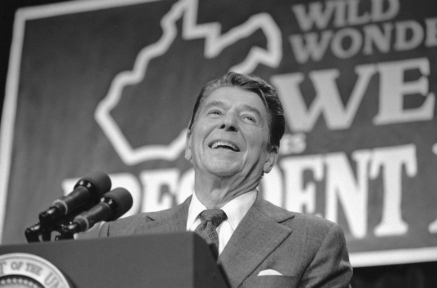 FILE - President Ronald Reagan smiles in front of an outline of the state of West Virginia while addressing a rally at Parkersburg High School in Parkersburg, W.Va., Oct. 29, 1984. (AP Photo/Barry Thu ...