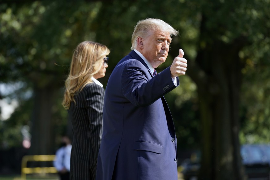 President Donald Trump and first lady Melania Trump walk to board Marine One at the White House, Tuesday, Sept. 29, 2020, in Washington, for the short trip to Andrews Air Force Base en route to Clevel ...