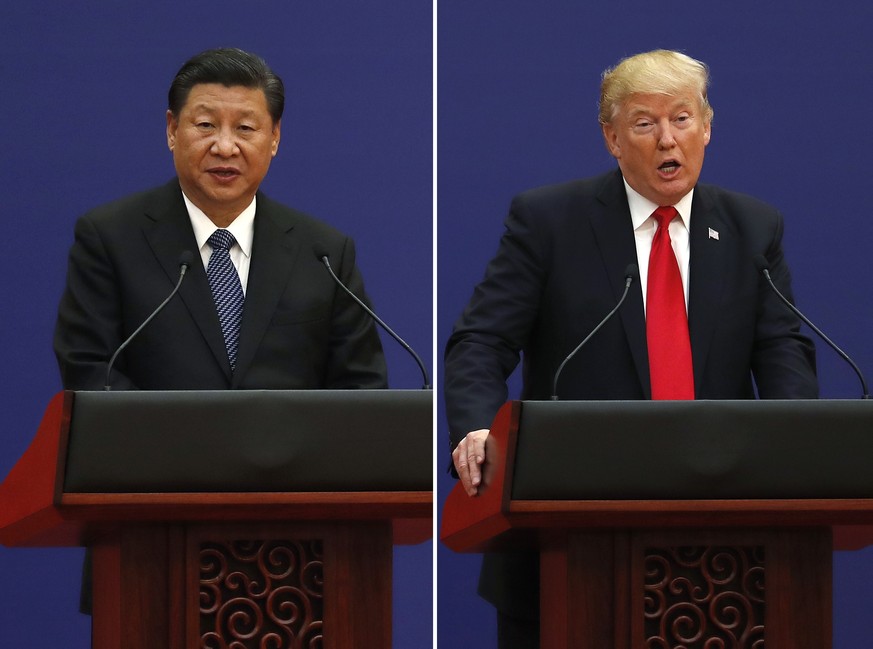 In this combination of Nov. 9, 2017 photos, U.S. President Donald Trump, right, and Chinese President Xi Jinping speak during a business event at the Great Hall of the People in Beijing. The brewing C ...