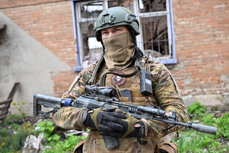 Russia Ukraine Military Operation Wagner Group 8418342 22.04.2023 A service member of Russia s private military company Wagner Group inspects an area in Artyomovsk, also known as Bakhmut, as Russia s  ...
