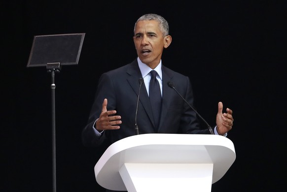 Former U.S. President Barack Obama, left, delivers his speech at the 16th Annual Nelson Mandela Lecture at the Wanderers Stadium in Johannesburg, South Africa, Tuesday, July 17, 2018. In his highest-p ...