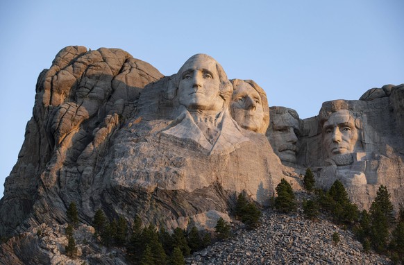 The first light of dawn hits Mt.Rushmore National Monument in Keystone, South Dakota on Saturday, July 4, 2020. President Donald Trump condemned the toppling of Confederate statues and announced an ex ...