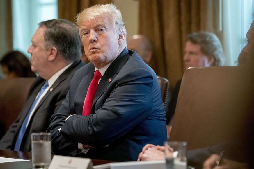 President Donald Trump, accompanied by Secretary of State Mike Pompeo, left, looks around the room during a cabinet meeting in the Cabinet Room of the White House, Thursday, Aug. 16, 2018, in Washingt ...