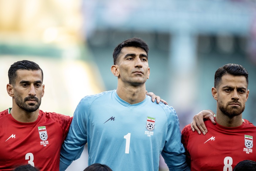 DOHA, QATAR - NOVEMBER 21: Iran players Ehsan Hajsafi, Alireza Beiranvand and Morteza Pouraliganji dont sing the national anthem before the FIFA World Cup, WM, Weltmeisterschaft, Fussball Qatar 2022 G ...