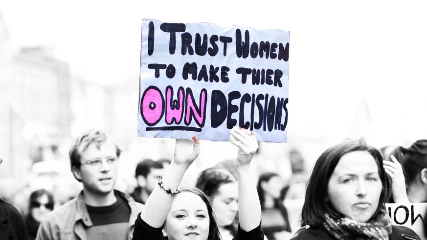 Dublin, Ireland - September 29, 2012: Dublin March for Choice 2012, Young woman holds hand made poster in act of support other women about their decisions regarding abortion