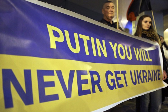 epa04132663 People protest against the Crimea situation near the Russian Embassy in Lisbon, Portugal, 19 March 2014. Ukrainian soldiers gave their country's navy headquarters in Crimea to pro-Russian ...
