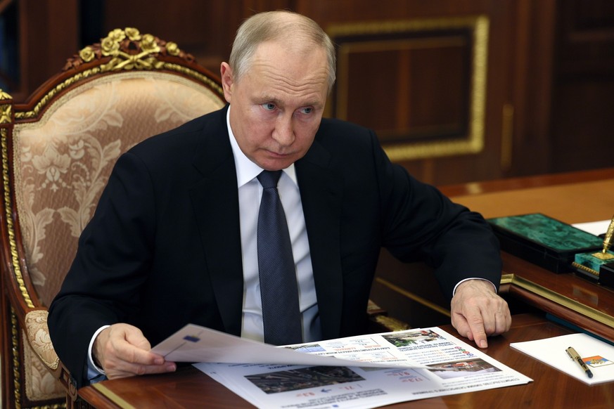 Russian President Vladimir Putin listens to Saratov region Governor Roman Busargin during their meeting at the Kremlin in Moscow, Russia, Tuesday, July 18, 2023. (Alexander Kazakov, Sputnik, Kremlin P ...