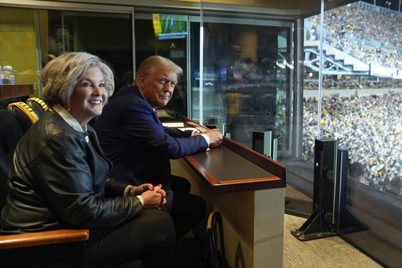 Republican presidential nominee former President Donald Trump sits with Susie Wiles as he attends the New York Jets football game against the Pittsburgh Steelers at Acrisure Stadium, Sunday, Oct. 20,  ...