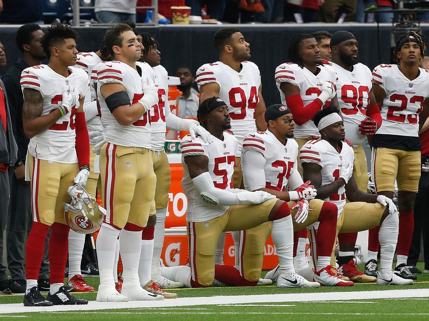 HOUSTON, TX - DECEMBER 10: Several San Francisco 49ers take a knee during the National Anthem before the game against the Houston Texans at NRG Stadium on December 10, 2017 in Houston, Texas. (Photo b ...